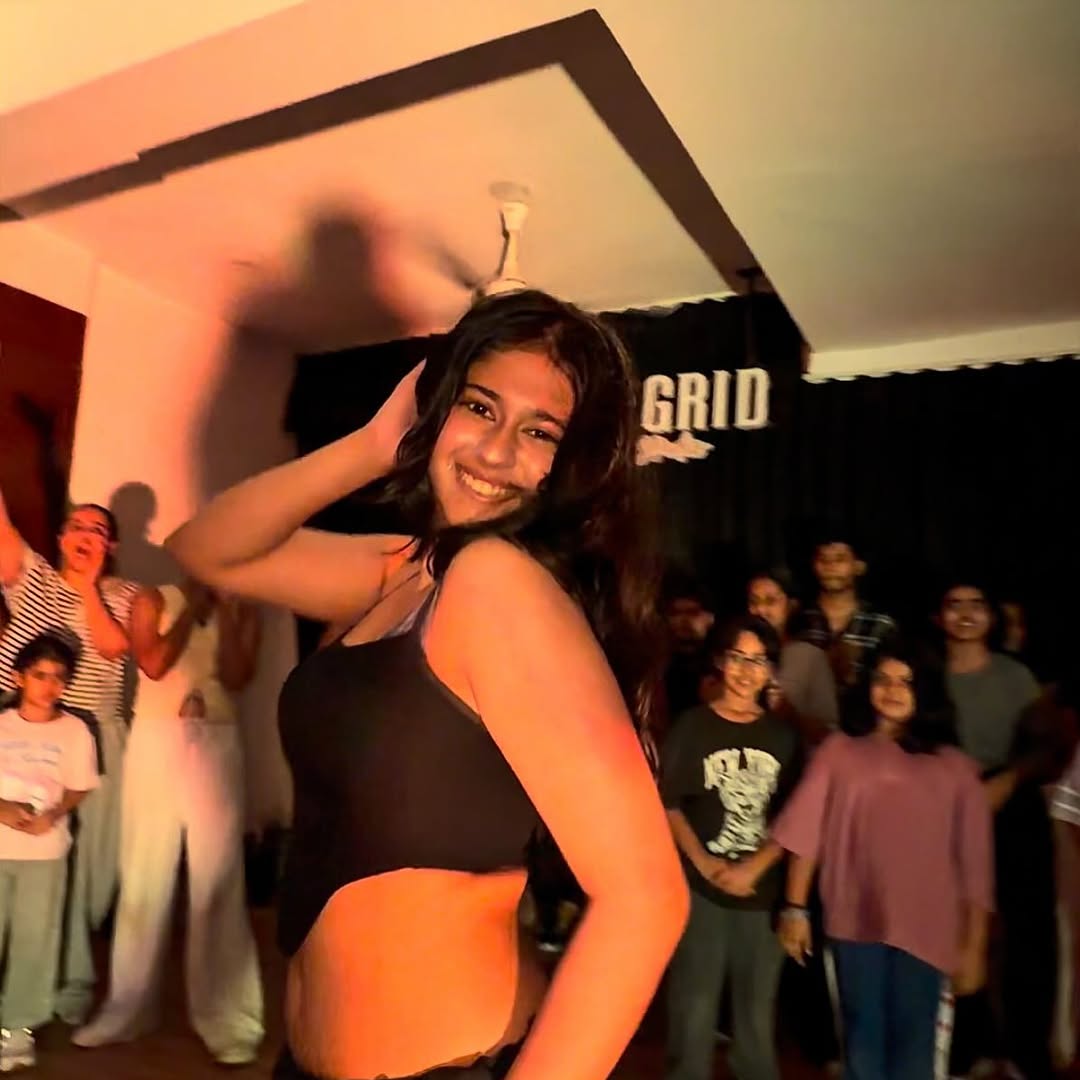 Dancer mid-move in the crowd circle